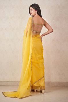 Sunshine yellow silk organza saree with sequins and beaded embroidered borders. Comes with a sage green dupion silk padded blouse.
Components: 2
Pattern: Hand embroidered
Type Of Work: Sequins, Beads
Neckline: Sweetheart
Sleeve Type: Sleeveless
Fabric: Saree : Silk organza, Blouse : Dupion silk
Color: Yellow
Other Details: 
Sheer back on blouse
Attached lining
Occasion: Wedding - Aza Fashions Party Organza Pre-draped Saree With Gota Work, Organza Pre-draped Saree With Gota Work For Party, Party Pre-draped Organza Saree With Gota Work, Yellow Organza Pre-draped Saree For Party, Fitted Silk Saree With Gota Work, Organza Saree With Gota Work For Party, Organza Pre-draped Saree With Gota Work, Fitted Organza Blouse Piece For Diwali, Silk Chiffon Pre-draped Saree With Sheer Dupatta