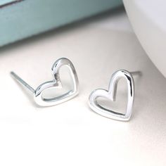 A stunning pair of irregular shaped open heart stud earrings made from sterling silver with a beautiful polished finish These silver heart stud earrings feature a classic butterfly and post fastening and are suitable for almost any age. A lovely Christmas gift, stocking filler or for a birthday treat for someone you love. Versatile and easy-to-wear, our stunning earrings shine when worn on their own or will add some sparkle to your stacked earring look in a second or third piercing. A wonderfull Silver Open Heart Minimalist Earrings, Silver Minimalist Open Heart Earrings, Sterling Silver Open Heart Earrings For Gift, Birthday Treat, Heart Shaped Frame, Silver Heart Earrings, Stacked Earrings, Silver Jewelry Earrings, Opal Earrings Stud