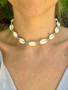 Hand made genuine cowrie shell choker necklace with aqua blue glass beads, knotted organic hemp and a coconut shell button. This necklace is metal free. It measures 16 inches from end to end. Please measure your neck or favorite necklace to make sure you get a good fit! If you are interested in a custom size, send me a message!  Each necklace is made to order and will ship 1-2 days from when you place your order.  These are also hand made with real natural shells and glass beads and may vary slightly from the picture due to Mother Nature making every shell unique :) Dainty Shell Necklace For Beach, Bohemian Turquoise Choker For Summer, Dainty Strand Jewelry For The Beach, Dainty Strand Jewelry For Beach, Bohemian Beaded Choker For Vacation, Dainty Strand Beach Jewelry, Bohemian Jewelry For Beach Vacation, Bohemian Beach Jewelry For Vacation, Adjustable Bohemian Choker For Vacation