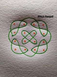 an image of a drawing on paper with green and orange dots in the shape of a flower