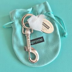 Supreme Tiffany & Co. Return To Tiffany Oval Tag Keyring From The 2021 Collaboration. Comes With Original Packaging (Box, Ribbon, Pouch, And The Tiffany Supreme Sticker Not Pictured). Never Used And Left In The Pouch In The Box With Silver Protector Still On (Pictured). Supreme Tiffany, Supreme Sticker, Box Ribbon, Return To Tiffany, Packaging Box, Key Card Holder, The Pouch, Card Holders, Tiffany & Co.