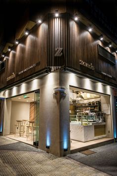 the outside of a restaurant at night with lights on