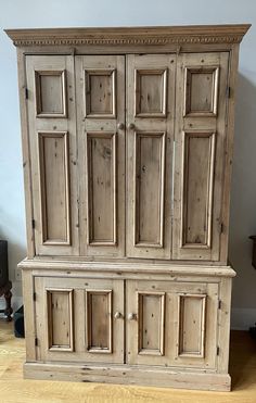 an old wooden cabinet sitting on top of a hard wood floor