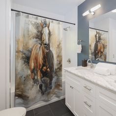 a bathroom with a shower curtain featuring horses