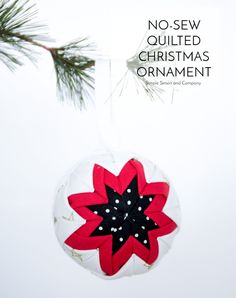 a christmas ornament hanging from a tree branch with the words no sew quilted christmas ornament on it