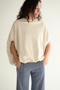 This sweatshirt has a very wide body and a ribbed hem that is gathered to create a unique silhouette. The body is wide, and the shoulders drop moderately, creating a sleeve length to just above the elbows finishing in a ribbed cuff. This is a simple yet stylish piece with an unexpected silhouette and comfortable fit. Jersey material with a good thickness and taut 'Kanoko' style structure (Moss stitch). It looks like a knit, but its firmness, lightness and fullness make it a very comfortable and beautiful material to wear. Crew neck. 5'' sleeves. Ribbed hem Length: 62 cm (front) / 68 cm (back) Body width: 84 cm (84 cm) Shoulder width: 77 cm (77 cm) Length from sleeve to sleeve: 48 cm 59% cotton, 41% polyester MADE IN JAPAN Brooklyn Sweatshirt, Peter Pan Collar Blouse, Petal Sleeve, Moss Stitch, Wide Body, Collar Blouse, Sleeve Detail, Designer Outfits Woman, Made In Japan