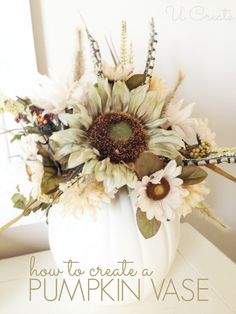 a white pumpkin decorated with flowers and leaves