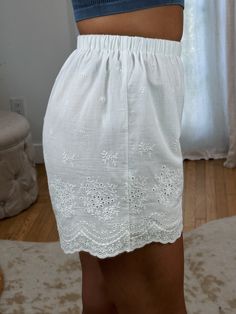 Absolutely adorable Vintage-esque High Waisted White Eyelet Shorts ft. double lining & stretchy elastic waist. These do not have pockets. Not necessarily see through but lighter/nude Undies are recommended! Maclaine is 5'7 and wearing a size Small. She typically wears a 26 in jeans and the small fit great! Waist does have stretchy elastic! 100% Cotton (lining 100% Viscose Rayon) Non-stretch Beach Shorts With Elastic Waistband, Beach Shorts With Elastic Waistband And Non-stretch, Bottoms With Elastic Waistband For Day Out, Summer Bottoms With Banded Waist For Daywear, Feminine Beige Bottoms With Elastic Waistband, Spring Bottoms With Banded Waist And Short Length, Spring Bottoms With Banded Waist, Chic Bottoms With Banded Waist For Spring, Daywear Bottoms With Elastic Waistband, Short Length