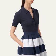 Carolina Herrera knit polo shirt Spread collar; half button front Short sleeves Relaxed fit Ribbed cuffs and hem Silk/cotton Dry clean Imported Fitted Navy Polo Sweater With Ribbed Collar, Navy Fitted Collared Polo Sweater, Fitted Navy Collared Polo Sweater, Navy Polo Shirt With Button Closure For Work, Navy Fitted Top With Collared Neckline, Navy Fitted Tops With Collared Neckline, Fitted Polo Shirt With Striped Collar, Elegant Short Sleeve Polo Shirt For Workwear, Elegant Navy Collared Tops