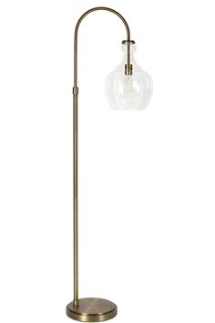 a floor lamp with a glass ball on it's arm and a metal base