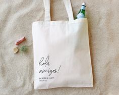 a white tote bag with the words babe, always written on it next to some corks