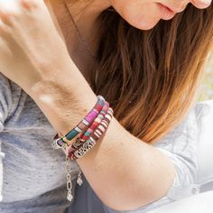 These fun, casual, and gorgeous bracelets are one of our best sellers and are perfect for adding some 'boho flair' to any outfit! Each piece features beautiful and colorful Guatemalan fabric wrapped around a bracelet that is detailed with silver beaded accents. Wear one or stack them - collect them all! As always... Handmade and Fair Trade! 7 1/2" L 100% Cotton Fabric Silver Beads and Clasp Colors/Patterns Will Vary Price is for one random Bohemian Fabric and Bead Bracelet WARNING: CHOKING HAZAR Bohemian Bangle Friendship Bracelets, Bohemian Braided Bracelets With Colorful Beads, Bohemian Pink Wrap Bracelet For Festival, Pink Bohemian Wrap Bracelet, Bohemian Silver Wrap Bracelet With Colorful Beads, Bohemian Woven Wrap Bracelet For Festivals, Silver Bohemian Friendship Bracelets For Festivals, Silver Bohemian Braided Bracelets, Multicolor Hand Wrapped Braided Bracelet