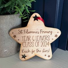 a wooden star ornament with the words, year and leaves class of 202