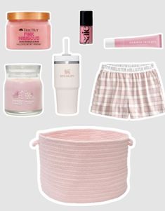 the contents of a woman's pink outfit including a straw hat, cup and other items