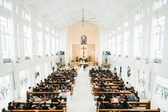 people sitting in pews at the alter of a church