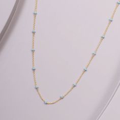 This meticulously crafted necklace is made with 14-karat gold and adorned with gentle, blue enamel accents. A sublime addition to any outfit, it brings a perfect touch of color and sophistication to your ensemble. Elegant Blue Chain Necklace, Gold Enamel Necklace With Cable Chain, Fine Jewelry Light Blue Pendant Necklace, Yellow Gold Enamel Jewelry With Adjustable Chain, Light Blue Pendant Necklace Fine Jewelry, Elegant Blue Beaded Chain Necklace, Blue 14k Gold Cable Chain Jewelry, Elegant Blue Jewelry With Beaded Chain, Elegant Blue Beaded Necklace With Adjustable Chain