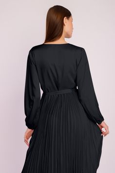 Our stunning Long Sleeve Pleated Satin Maxi Dress is an elegant and fashionable addition to your evening wear collection. Featuring long puffed sleeves, a crossover front with a dainty waist tie, and a long pleated satin skirt, this beautiful ensemble is the ideal choice for any party or formal event. Formal V-neck Mini Dress With Pleated Sleeves, Silk V-neck Pleated Dress, Elegant Long Sleeve Pleated Belted Dress, Elegant V-neck Belted Mini Dress, Fitted Satin Pleated Dress, Satin V-neck Dress With Pleated Sleeves, Satin Dress With Tie Waist For Date Night, Chic Satin Dress With Pleated Waist, Formal V-neck Satin Dress