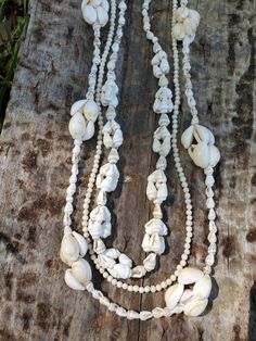 "This is a gorgeous set of three shell and beaded necklaces. The sizes of the necklaces are 36\", 34\" and 32\"." Hand-strung Multi-strand Beach Necklaces, Hand-strung Long Beaded Necklace For Beach, Bohemian Shell Jewelry With Large Beads, Shell Necklaces With Large Round Beads, Bohemian Shell Necklace With Round Mother Of Pearl Beads, Multi-strand Hand-strung Beaded Necklaces For Beach, Bohemian Mother Of Pearl Shell Necklace With Round Beads, Bohemian Shell-shaped Pearl Necklace, Handmade Multi-strand Shell Necklace For Beach