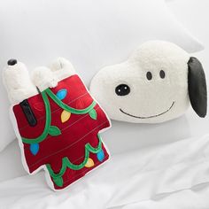 a pillow with a stuffed dog on it next to a pillow that is shaped like a christmas stocking