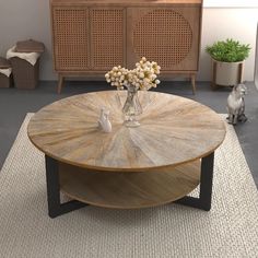 a coffee table with flowers in a vase on top