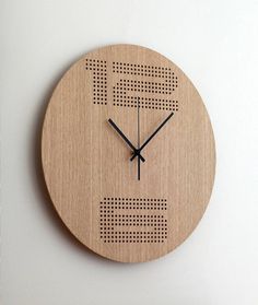 a clock made out of wood with the letter e on it's face and hands