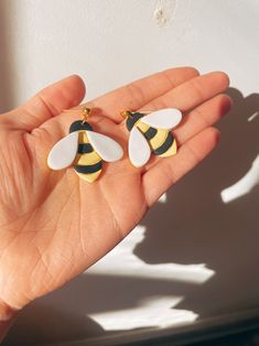 a person is holding some kind of earrings in their hand