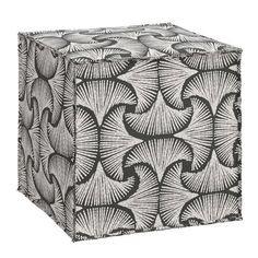 a black and white photo of a square box with an intricate design on the front