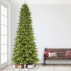 a living room with a christmas tree in the corner and a bench next to it