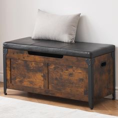 a wooden storage bench with two drawers and a cushion on it's backrest