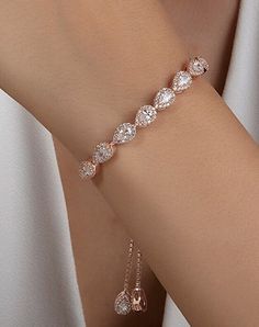 "Perfect for brides, bridesmaids, mother of the bride, mother of the groom or maid of honor. A piece of jewelry that you are going to wear for years to any special occasion. An elegant silver bridal bracelet - perfect for your wedding day or as a gift for your bridesmaids. The bracelet in silver has the most beautiful sparkle with  cubic zirconia stones. If you want to combine it with earrings and necklace, I leave the link here. https://www.etsy.com/uk/listing/1276071109/silver-teardrop-crystal-bridal-necklace https://www.etsy.com/uk/listing/1243959614/silver-teardrop-crystal-bridal weight:8.22g * Handmade with love ♡ * Material: 925 Sterling Silver * Standard Bracelet Length: 16 + 4cm extension. If you need it longer or shorter, please leave us a message. * Finish: 18K Gold, 18k Rose Gol Bride Bracelet, Bracelet In Silver, Bracelet Wedding, Silver Ornaments, Earrings And Necklace, Nail Jewelry, Bridal Bracelet, Custom Name Necklace, Wedding Jewellery