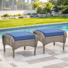 two wicker benches sitting next to a swimming pool