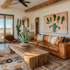 a living room filled with furniture and a large painting hanging on the wall above it