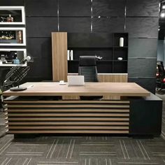 an office desk with black and wood accents