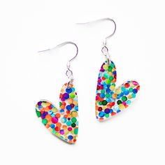 These Small Confetti Heart Acrylic Earrings go perfectly with any color outfit and also make a great gift! They are hypoallergenic and lightweight.  SIZING: Hearts are approximately 7/8 inch wide & 1 1/8 inches long. Drop length is approximately 2 inches.  MATERIALS: Silver stainless steel earring hooks are hypoallergenic and will not tarnish. Jump rings are sterling silver. Earrings are made of acrylic.  PACKAGING: Earrings arrive in a cotton filled swirl white jewelry box gift case. Perfect fo Trendy Colorful Heart-shaped Jewelry, Cute Multicolor Hypoallergenic Earrings, Cute Multicolor Earrings For Mother's Day, Playful Heart-shaped Earrings For Parties, Trendy Heart Print Earrings For Party, Playful Heart Shaped Party Earrings, Playful Heart-shaped Party Earrings, Cute Multicolor Earrings With Heart Charm, Multicolor Nickel-free Heart Earrings