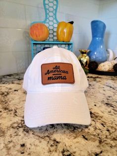 Back in stock 2024!! Ships very quickly! White or black distressed or non distressed baseball hat with Velcro closure. Leatherette patch with American Mama design Hat and patch may not be the exact same as the picture since each one is handmade with care. Can do custom patches.  Perfect for a mothers day gift or a birthday present. 🔥Head over to www.mom-concepts.com for more products from our shop 🔥 Casual Snapback Baseball Cap With Patches, Casual Cotton Hats With Patches, Casual Flat Brim Hat With Letter Patch, Everyday Baseball Cap With Logo Patch And Flat Brim, Baseball Cap With Logo Patch And Flat Brim, Casual Snapback Hat With Embroidered Patch, Casual Outdoor Baseball Cap With Leather Patch, Casual Adjustable Hats With Patches, Casual Trucker Hat With Leather Patch