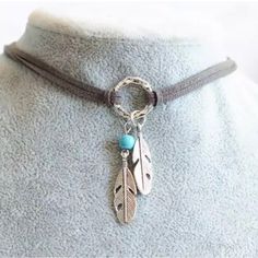 Soft Leather Choker Necklace With Silver Circle Center. Two Small Silver Feathers And A Turquoise Bead Accent The Necklace. A Little Bit Boho, A Little Bit Western. Adjustable To Fit Most Any Size Neck. 17.5” Long With 2” Extender. Feather Pendant Necklace, Charm Choker Necklace, Leather Choker Necklace, Turquoise Leather, Fashion Bohemian, Feather Pendant, Silver Feather, Black Choker, Costume Jewelry Necklaces