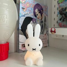 a white rabbit lamp sitting on top of a table