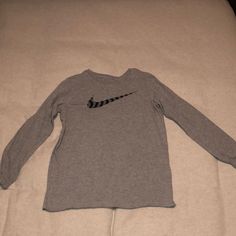 Washed But Never Worn! Nike Boys Graphic Long Sleeved Tee. Color Is Gray With A Black Striped Swoosh On The Front. Size Is Large. Nike Long Sleeve Cotton T-shirt, Nike Cotton Long Sleeve T-shirt, Nike Gray Tops For Fall, Nike Tops With Letter Print For Fall, Nike Cotton Tops For Fall, Nike Gray Tops With Letter Print, Nike Long Sleeve Tops With Letter Print, Nike Graphic Print Tops For Fall, Nike Casual Long Sleeve Shirt