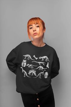 Dinosaur Sweatshirt Skeletons Sweater Goblincore Clothing Aesthetic Clothing Dark Academia Pullover Dino Sweatshirt Dino Crewneck Sweater. Sweatshirt features: *Made from 50% cotton, 50% polyester (heathers colors are 40% cotton, 60% polyester) *Medium-heavy fabric (8.0 oz/yd² (271.25 g/m *Loose fit *Oversized if you choose 1-2 sizes bigger *Sewn-in label *Runs true to size *Crewneck *Unisex style *Ribbed knit collar *Without itchy side seams Canvas Tote Bag features (available in black color): Casual Dinosaur Print Tops For Fall, Long Sleeve Top With Dinosaur Print For Fall, Cotton Tops With Dinosaur Print For Fall, Cotton Top With Dinosaur Print For Fall, Casual Dinosaur Print Crew Neck Sweatshirt, Casual Dinosaur Print Tops For Streetwear, Winter Long Sleeve Tops With Dinosaur Print, Dinosaur Print Long Sleeve Tops For Winter, Black Dinosaur Print Crew Neck Top