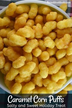 a bowl filled with corn puffs sitting on top of a checkered table cloth