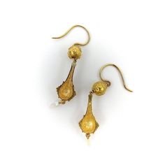 This is part of Chairish’s Fine Jewelry assortment.  This is a stunning pair of 14k Etruscan Revival drop earrings featuring intricate gold detailing and a delicate Mississippi river pearl dangling element. The shape of the earrings resembles an elongated urn hanging from an Etruscan Revival ball.   Both ball and urn have delicate wirework and granulation indicative of Etruscan Revival jewellery. They weigh 4.8 grammes, and measure 2” from the top of the backing to the bottom of the seed pearl, Hallmarked Yellow Gold Pearl Drop Earrings, Formal Brass Pearl Drop Earrings, Yellow Gold Pearl Drop Earrings In Brass, Ornate Yellow Gold Pearl Drop Jewelry, Antique Gold Dangle Pearl Earrings, Yellow Gold Pearl Drop Dangle Chandelier Earrings, Yellow Gold Pearl Earrings With Intricate Design For Gift, Victorian Style Dangle Earrings With Pearl Drop, Victorian Pearl Drop Dangle Earrings