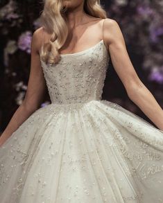 a model walks down the runway in a wedding dress