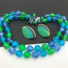 254.00 USD Vintage blue green, beaded high end, jewelry set, 1950's 1960's jewelry, mid century jewelry, beaded jewelry set, collectible necklace earring set Very nice colorful jewelry set in very good vintage condition. The necklace measures 17 1/2 inches long and the earrings are 1 1/2 x 1 inch. A very nice-looking married set and a great addition to any outfit or jewelry collection. #vintage #blue #green #multistrand #2strand #necklace #earrings #jewelryset d4 1970 Vintage Minnie Mouse Green Clothing Necklace, Retro Jewelry With Faceted Beads, Vintage Turquoise Jewelry With Colorful Beads, Mid-century Green Formal Jewelry, Retro Blue Beaded Jewelry, Blue Beaded Retro Jewelry, Vintage Green Jewelry With Faceted Beads, Blue Mid-century Jewelry For Formal Occasions, Mid-century Blue Formal Jewelry