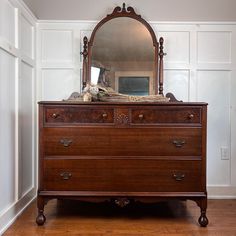 a dresser with a mirror on top of it