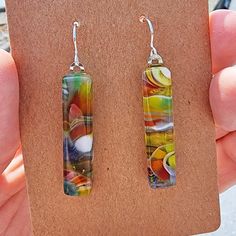 For the person who likes to wear one-of-a-kind art glass! These colorful, modern earrings are made with a detailed process of fusing, hot working and cold working, and have been in and out of various kilns eight or more times. The glass is attached to silver-plated bails and dangle from sterling silver ear wires.  I handmake my earrings in my home studio in Bellingham, Washington. The glass is approximately 1.25 inches long (plus ear wire), .25 inches wide and .2 inches thick.  Truly one-of-a-ki Modern Nickel-free Glass Earrings, Colorful Handmade Modern Earrings, Artsy Multicolor Rectangular Earrings, Hand Painted Multicolor Modern Earrings, Multicolor Glass Drop Earrings, Artistic Multicolor Earrings With Unique Variations, Handmade Modern Multicolor Earrings, Modern Glass Earrings With Ear Wire, Modern Glass Earrings For Gifts