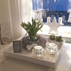 a tray with candles and flowers on it