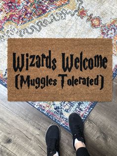 someone standing in front of a welcome mat that says wizard's welcome muggles toerated