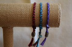 "These are handmade with multi-colored embroidery threads and glass, metal, acrylic and/or ceramic beads. The standard length is 8\". They are easy to put on and easy to take off. They look great worn alone but look fantastic if you put a combination of bracelets together. These handwoven bracelets are one of a kind and make a perfect gift for someone special. They are unisex and stylish for any age. You can special order any color combination (up to 5 colors) and length. Suggested Lengths: Male Adjustable Woven Braided Bracelet With Round Beads, Traditional Adjustable Purple Bracelets, Adjustable Braided Bracelet With Round Beads, Traditional Adjustable Purple Bracelet, Adjustable Purple Bohemian Braided Bracelets, Bohemian Woven Braided Bracelets, Purple Bohemian Braided Bracelet With Sliding Knot, Purple Bohemian Friendship Bracelets With Sliding Knot, Adjustable Handwoven Purple Jewelry