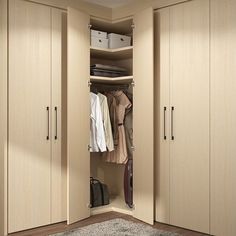 an open closet with clothes hanging on the doors and other items in the cupboards