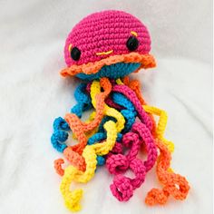 a crocheted octopus is laying on the bed